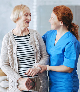 a nurse and her patient smiling at each other