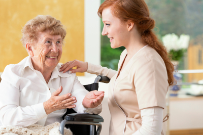 caregiver talking with her senior patient